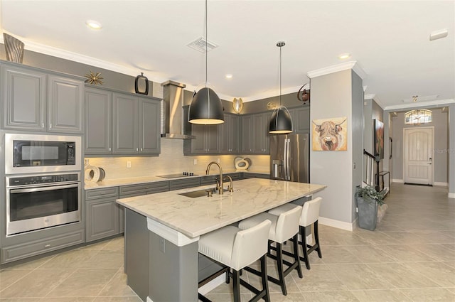 24193 Gallberry Dr, Venice, FL 34293 - kitchen with a sink, wall chimney range hood, appliances with stainless steel finishes, gray cabinets, and backsplash