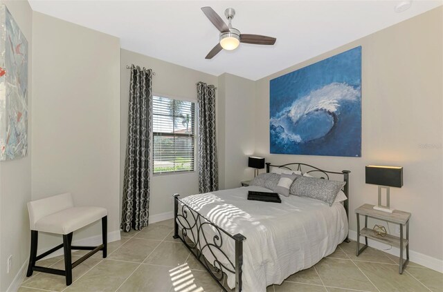 24193 Gallberry Dr, Venice, FL 34293 - bedroom with light tile patterned floors, baseboards, and ceiling fan