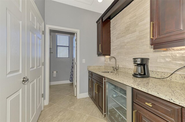 24193 Gallberry Dr, Venice, FL 34293 - bar with light tile patterned floors, backsplash, beverage cooler, a sink, and bar