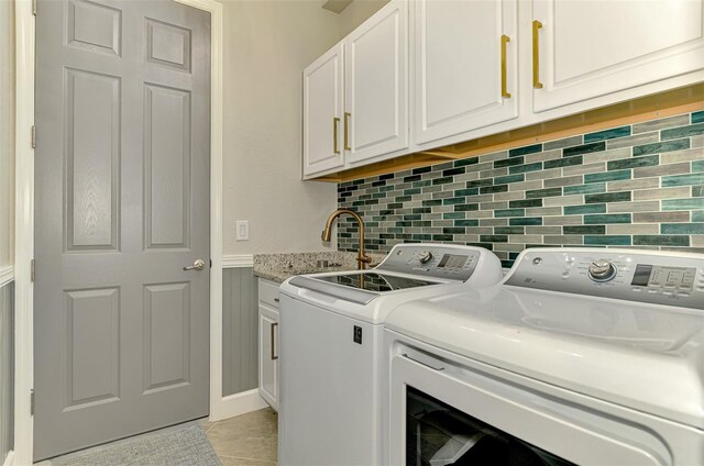 24193 Gallberry Dr, Venice, FL 34293 - clothes washing area with washer and clothes dryer, cabinet space, and light tile patterned flooring