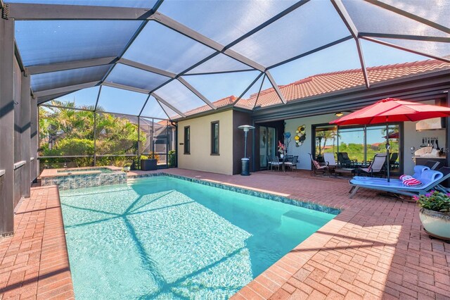 24193 Gallberry Dr, Venice, FL 34293 - view of swimming pool featuring a patio area, a pool with connected hot tub, and glass enclosure