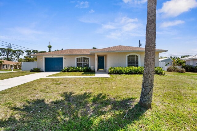 511 Porpoise Rd, Venice, FL 34293 - ranch-style home featuring an attached garage, driveway, a front lawn, and stucco siding