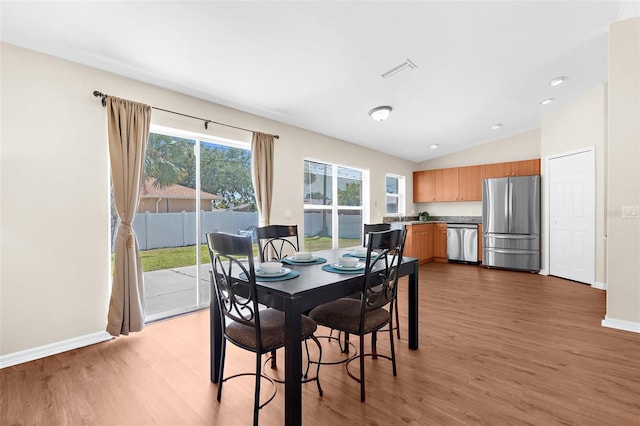 511 Porpoise Rd, Venice, FL 34293 - dining room with light wood-type flooring, baseboards, vaulted ceiling, and visible vents