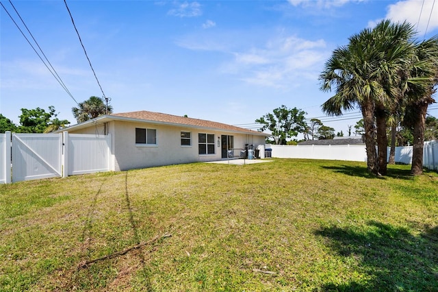 511 Porpoise Rd, Venice, FL 34293 - back of house with a fenced backyard, a gate, a yard, and stucco siding