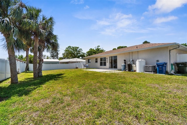511 Porpoise Rd, Venice, FL 34293 - back of house featuring a fenced backyard, central air condition unit, a patio area, a lawn, and stucco siding