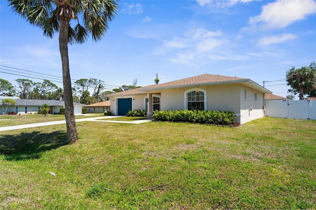 511 Porpoise Rd, Venice, FL 34293 - single story home with a front lawn, concrete driveway, fence, a garage, and stucco siding