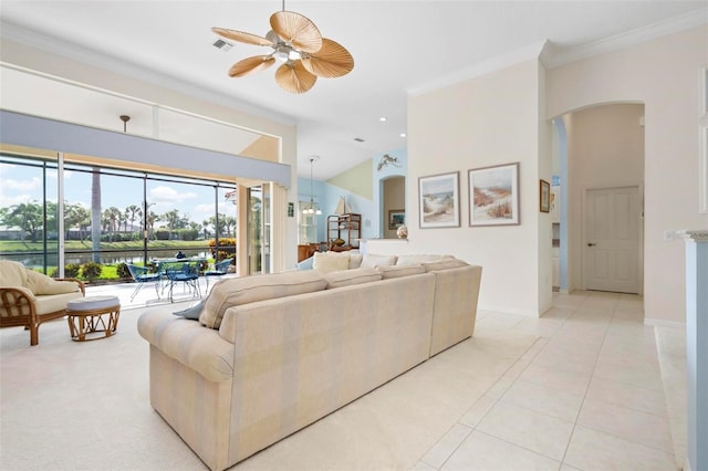 living area featuring light tile patterned floors, baseboards, arched walkways, ornamental molding, and a ceiling fan