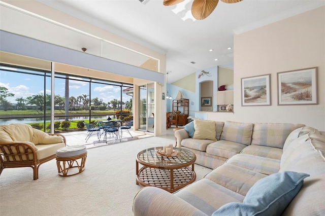 carpeted living room featuring ceiling fan, lofted ceiling, and a water view