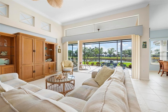 living area featuring plenty of natural light, baseboards, crown molding, and light tile patterned flooring