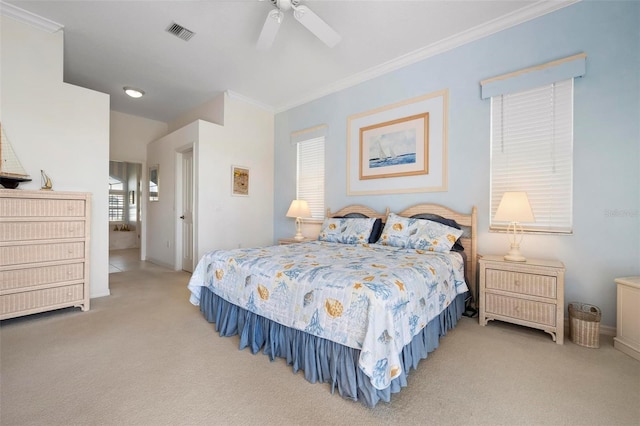 bedroom with carpet flooring, visible vents, crown molding, and ceiling fan