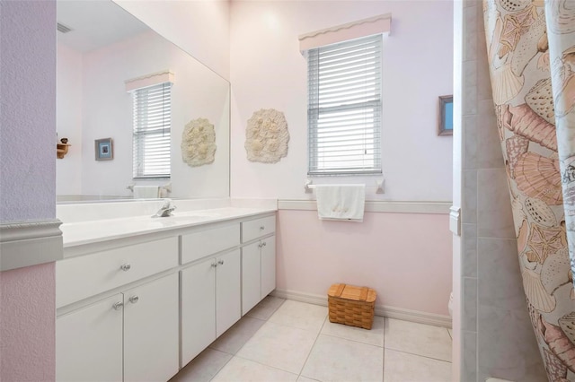 full bath featuring tile patterned flooring, vanity, curtained shower, and a healthy amount of sunlight