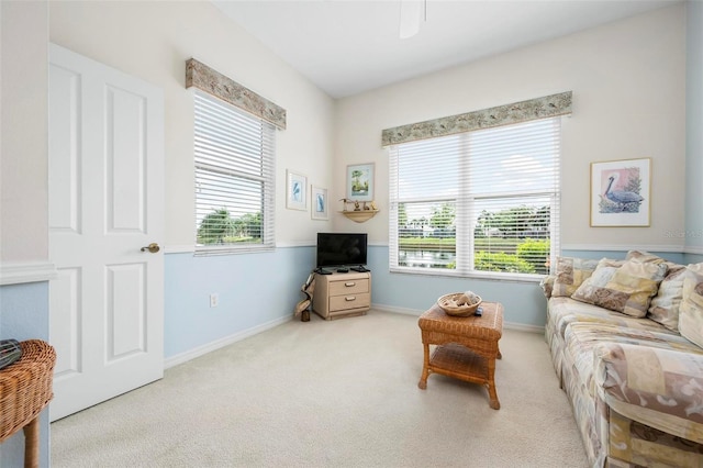 sitting room with ceiling fan, baseboards, and carpet floors