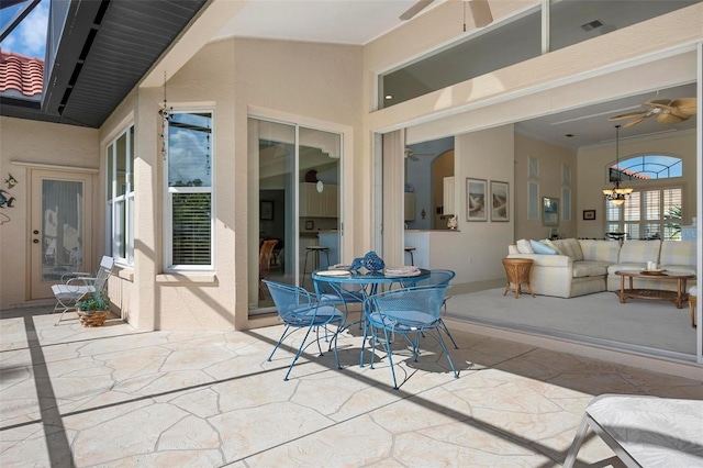 view of patio featuring an outdoor living space, outdoor dining area, and a ceiling fan