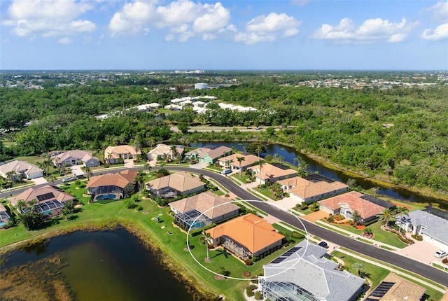 birds eye view of property with a water view and a residential view