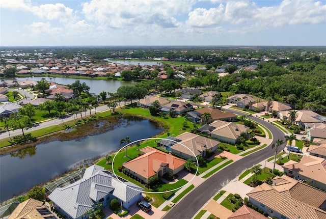 drone / aerial view featuring a water view and a residential view