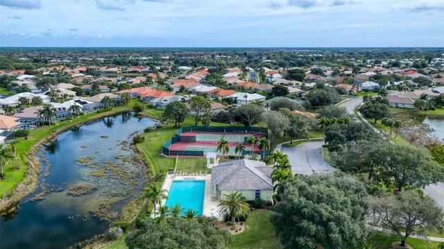drone / aerial view featuring a residential view and a water view