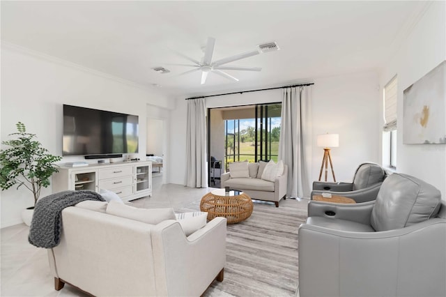24153 Spartina Dr, Venice, FL 34293 - living room with crown molding, ceiling fan, and visible vents
