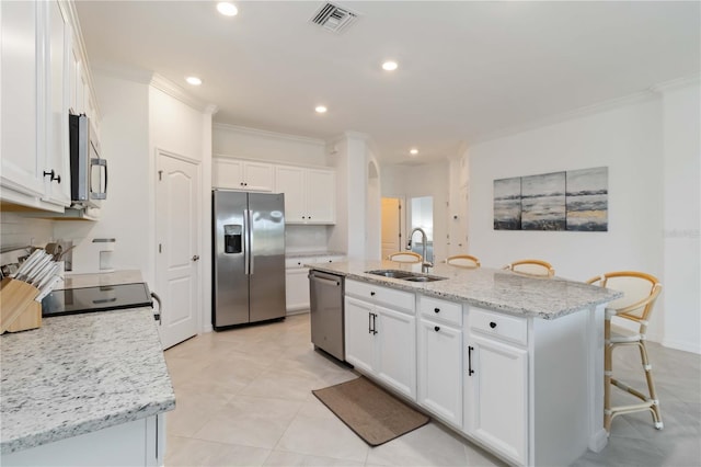 24153 Spartina Dr, Venice, FL 34293 - kitchen featuring visible vents, white cabinets, a sink, crown molding, and stainless steel appliances