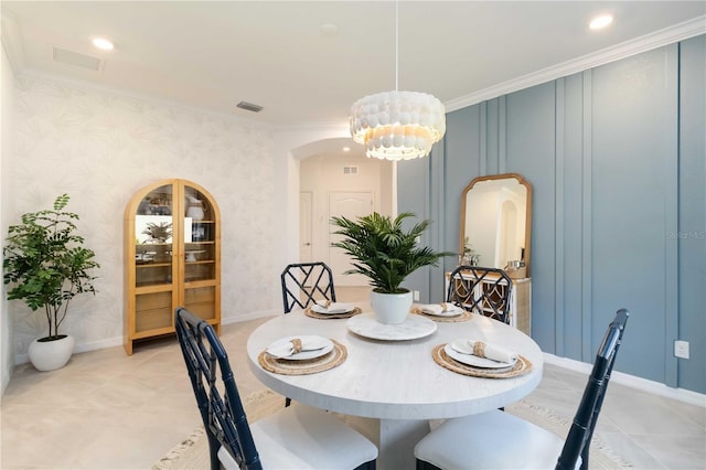 24153 Spartina Dr, Venice, FL 34293 - dining area featuring wallpapered walls, an inviting chandelier, crown molding, visible vents, and arched walkways