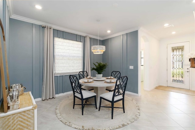 24153 Spartina Dr, Venice, FL 34293 - dining room with arched walkways, baseboards, and crown molding