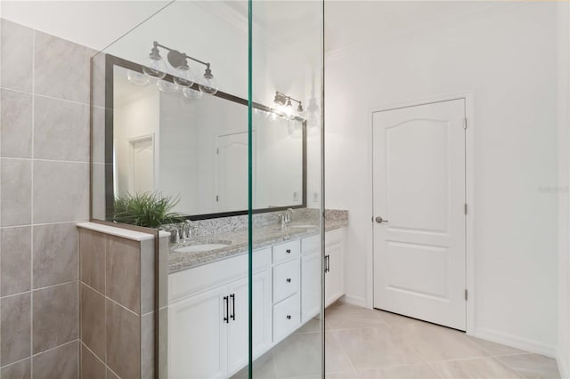 24153 Spartina Dr, Venice, FL 34293 - bathroom with tile patterned floors, double vanity, a sink, and baseboards