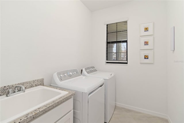 24153 Spartina Dr, Venice, FL 34293 - washroom with light tile patterned floors, baseboards, a sink, laundry area, and washing machine and clothes dryer