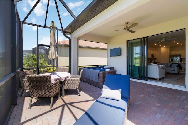 24153 Spartina Dr, Venice, FL 34293 - view of patio / terrace with an outdoor living space, outdoor dining space, a ceiling fan, and glass enclosure