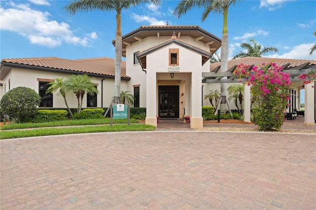 24153 Spartina Dr, Venice, FL 34293 - mediterranean / spanish home featuring a tile roof, a pergola, and stucco siding