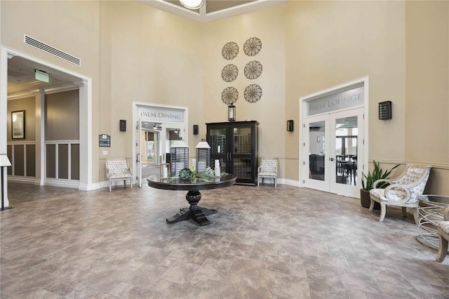 24153 Spartina Dr, Venice, FL 34293 - interior space with french doors, stone finish floor, and a towering ceiling