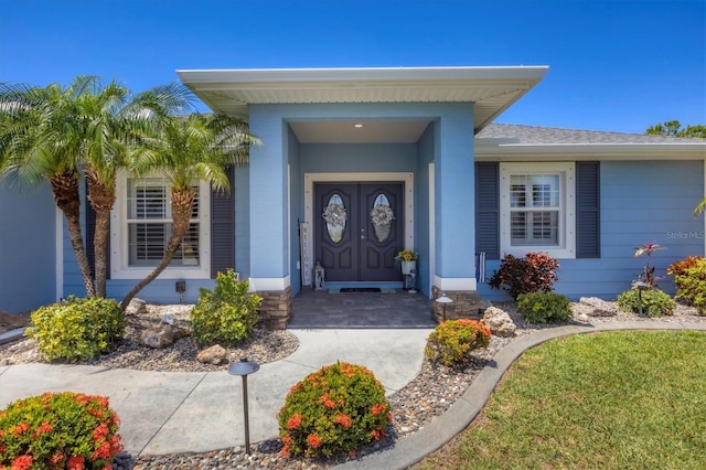 194 Sportsman Rd, Rotonda West, FL 33947 - view of exterior entry with a shingled roof