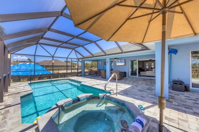 194 Sportsman Rd, Rotonda West, FL 33947 - view of pool featuring a ceiling fan, a patio area, glass enclosure, and a pool with connected hot tub