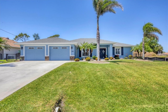 194 Sportsman Rd, Rotonda West, FL 33947 - ranch-style home featuring a garage, concrete driveway, fence, a front yard, and stucco siding