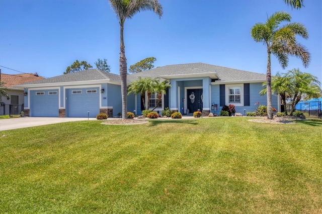 194 Sportsman Rd, Rotonda West, FL 33947 - ranch-style house featuring an attached garage, a front lawn, fence, and concrete driveway