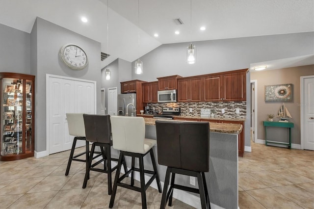 194 Sportsman Rd, Rotonda West, FL 33947 - kitchen featuring high vaulted ceiling, light tile patterned floors, a breakfast bar area, appliances with stainless steel finishes, and visible vents
