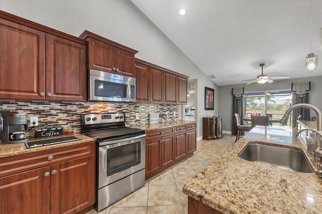 194 Sportsman Rd, Rotonda West, FL 33947 - kitchen featuring a sink, light tile patterned flooring, vaulted ceiling, backsplash, and appliances with stainless steel finishes