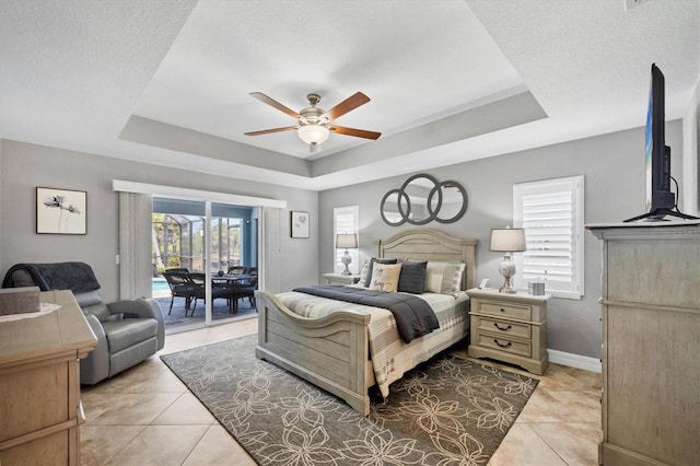 194 Sportsman Rd, Rotonda West, FL 33947 - bedroom with a raised ceiling, access to exterior, a ceiling fan, light tile patterned floors, and baseboards
