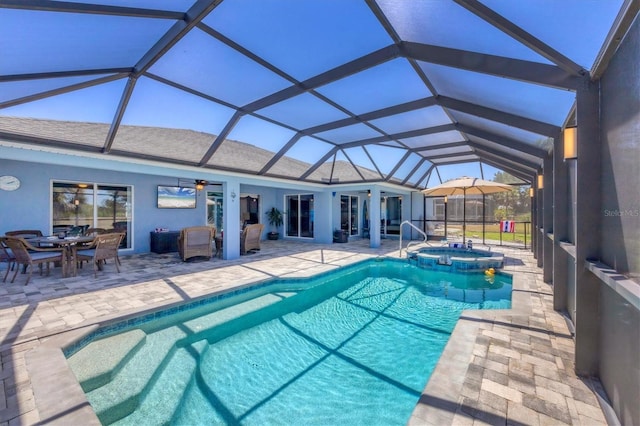 194 Sportsman Rd, Rotonda West, FL 33947 - view of pool featuring a patio area, ceiling fan, outdoor dining area, a lanai, and a pool with connected hot tub