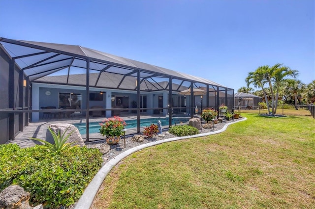 194 Sportsman Rd, Rotonda West, FL 33947 - back of property with a lawn, an outdoor pool, a patio area, and glass enclosure