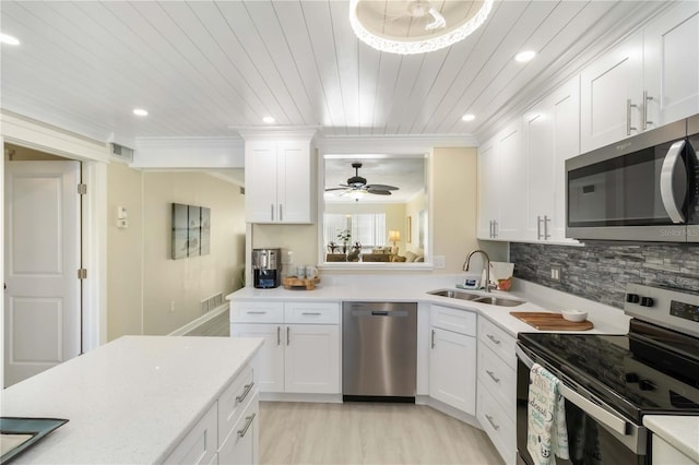 kitchen with white cabinetry, visible vents, appliances with stainless steel finishes, light countertops, and a sink