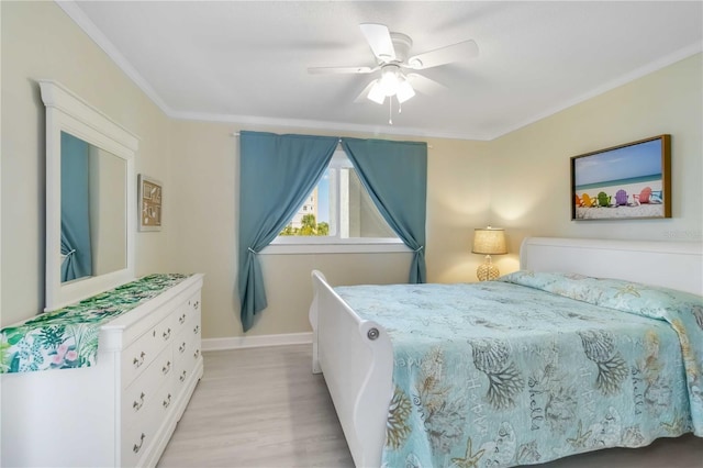 bedroom featuring crown molding, baseboards, ceiling fan, and light wood-style floors