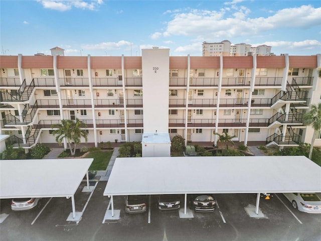 view of property with covered and uncovered parking