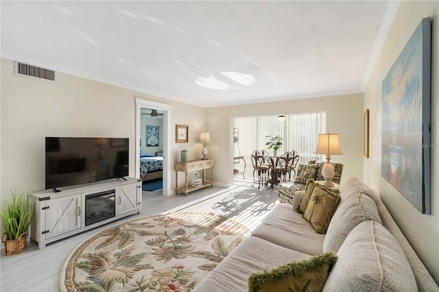230 Santa Maria St Unit 333, Venice, FL 34285 - living room with light wood finished floors, baseboards, and ornamental molding