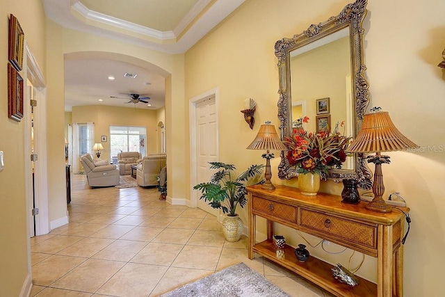 2542 Cortenova Ct, Venice, FL 34292 - corridor featuring crown molding, light tile patterned floors, arched walkways, visible vents, and baseboards