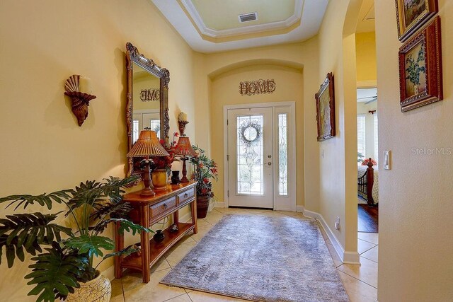 2542 Cortenova Ct, Venice, FL 34292 - tiled entrance foyer featuring arched walkways, a tray ceiling, visible vents, and baseboards