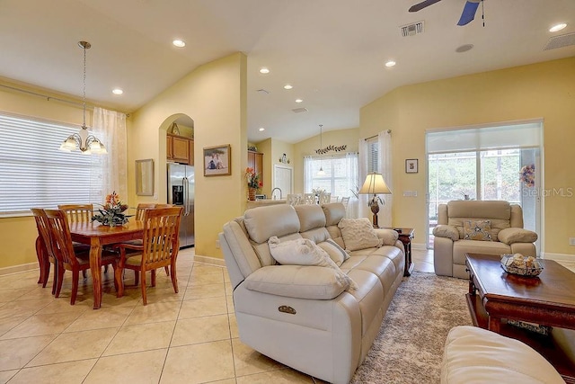 2542 Cortenova Ct, Venice, FL 34292 - living room with light tile patterned floors, visible vents, ceiling fan with notable chandelier, and vaulted ceiling