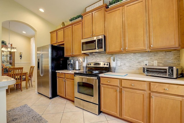 2542 Cortenova Ct, Venice, FL 34292 - kitchen featuring tasteful backsplash, light countertops, appliances with stainless steel finishes, and light tile patterned flooring