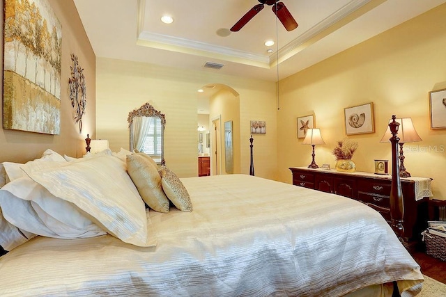 2542 Cortenova Ct, Venice, FL 34292 - bedroom with crown molding, visible vents, a raised ceiling, and arched walkways