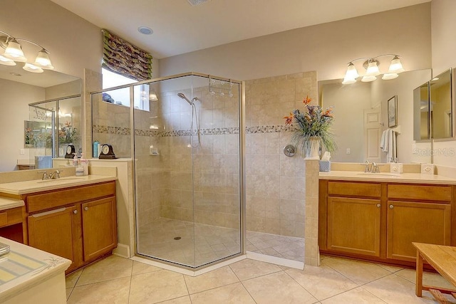 2542 Cortenova Ct, Venice, FL 34292 - bathroom featuring tile patterned floors, two vanities, a sink, and a stall shower