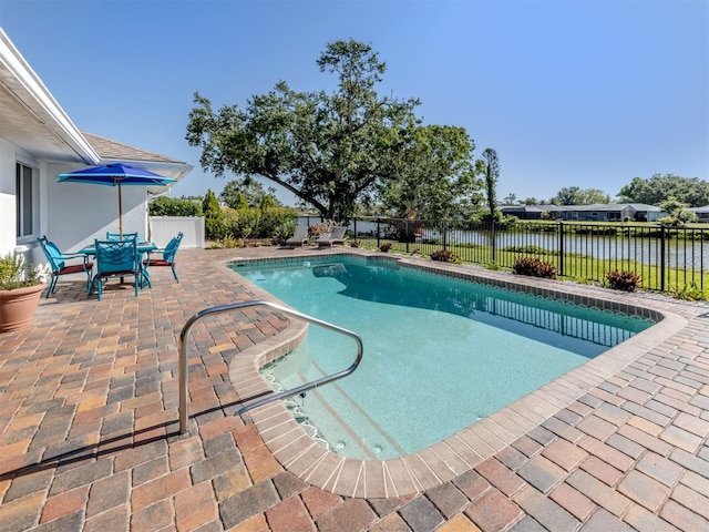 1232 Pine Needle Rd, Venice, FL 34285 - view of swimming pool featuring a water view, a patio area, and a fenced backyard