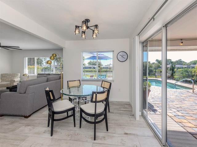 1232 Pine Needle Rd, Venice, FL 34285 - dining space featuring a wealth of natural light, a notable chandelier, and baseboards